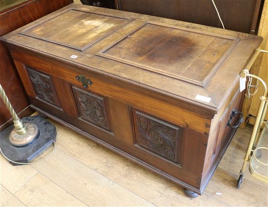 A walnut coffer with three carved panels W.134cm